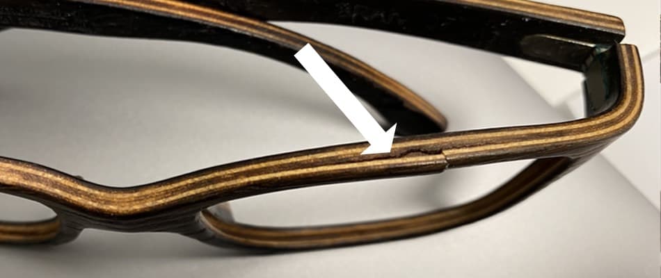 The picture shows a crack in a wooden glasses frame